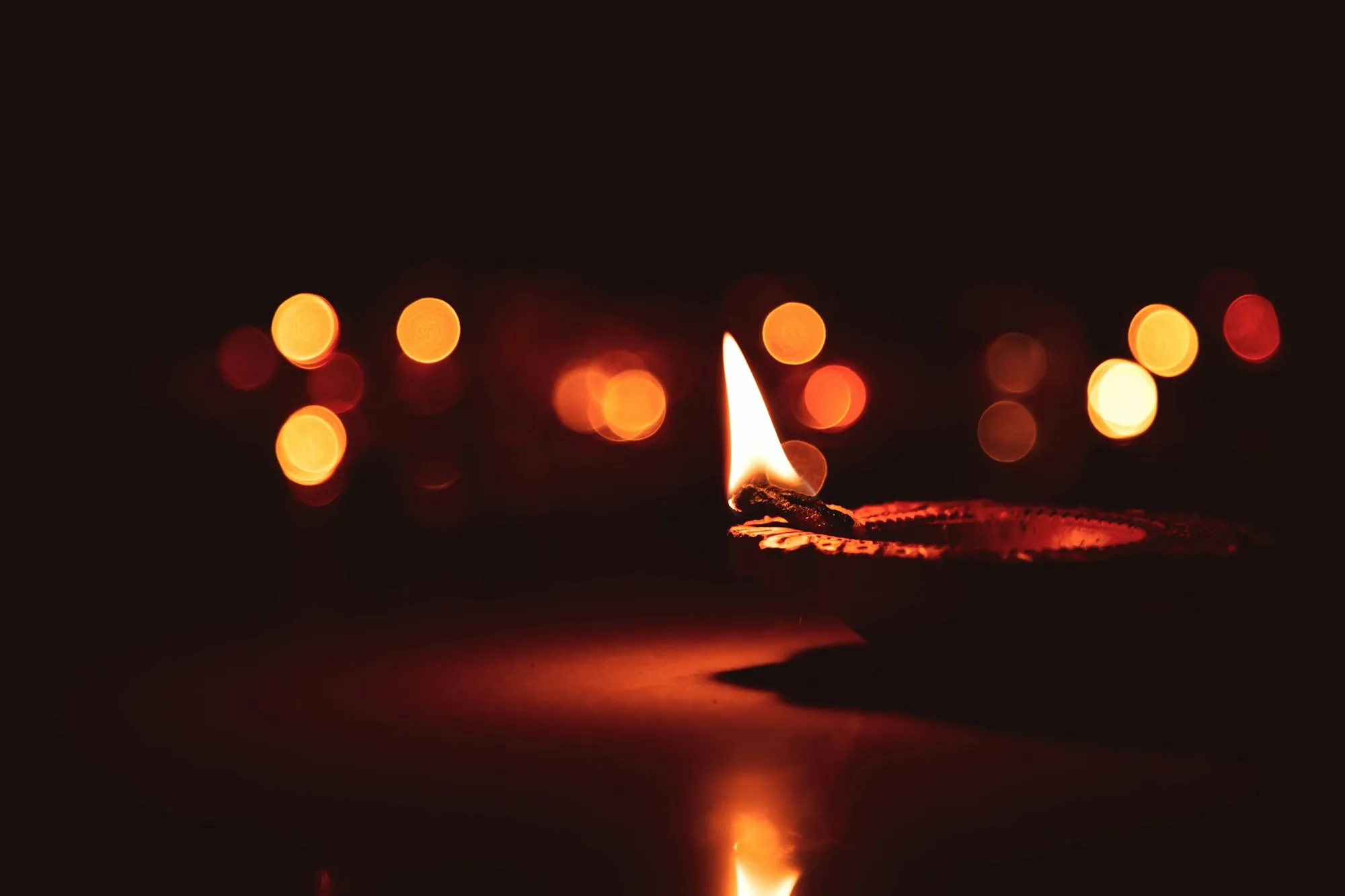 A single oil lamp against soft bokeh