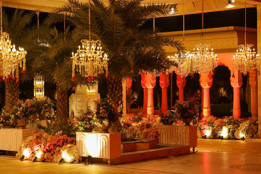 A grand venue hung with chandeliers and florals